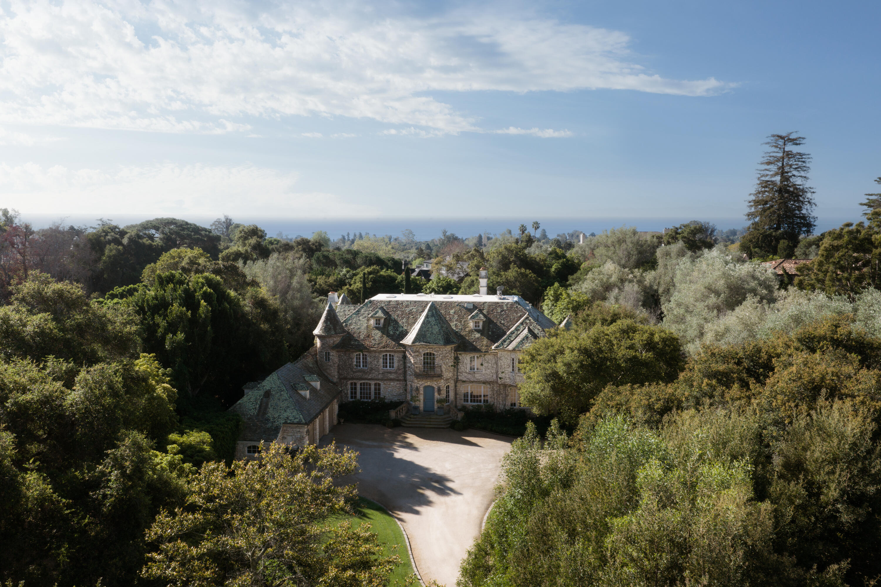 1567 East Valley Road Montecito, CA 93108 - Photo 1 of 34 an aerial view of a house with a yard and mountain view in back