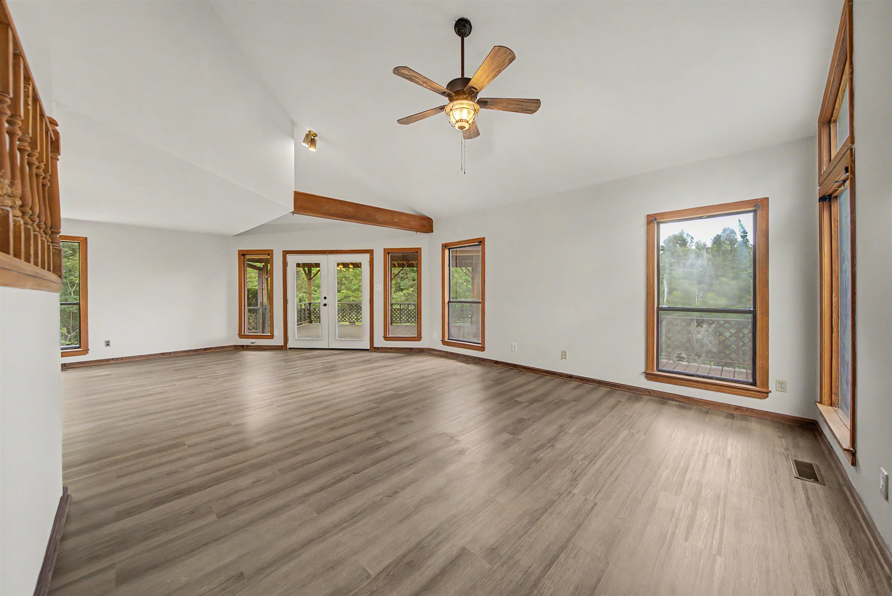 2380 Dunaway Road Selmer, TN 38375 - Photo 16 of 39 Spacious living area featuring wood-finish flooring, vaulted ceilings, and exposed wood beam accents