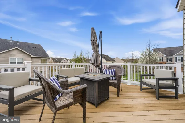 a view of a terrace with wooden benches and city view