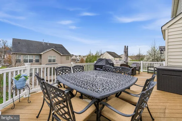 a view of a roof deck with table and chairs