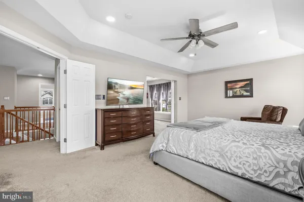 a bedroom with a bed and ceiling fan