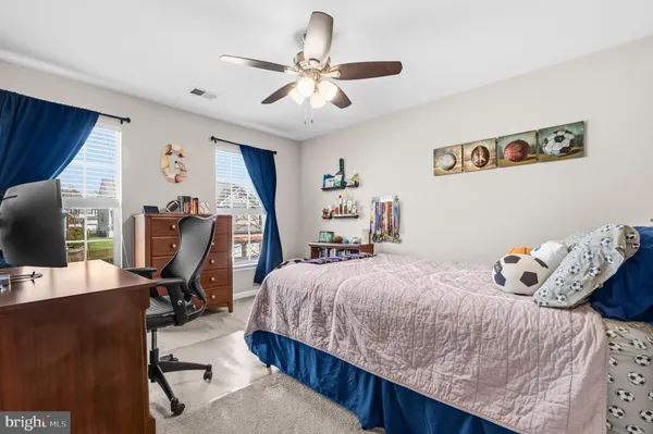 a bedroom with a bed and a desk