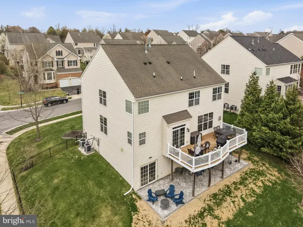 a aerial view of a house with swimming pool and a yard