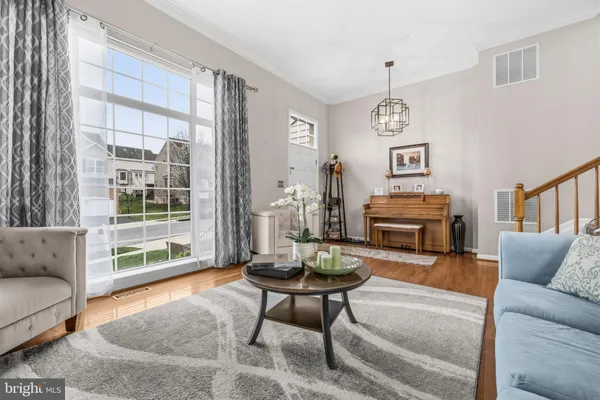 a living room with furniture a fireplace and a window