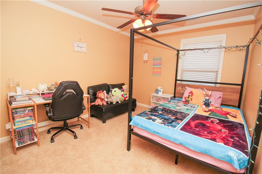 2508 Morgan Chase Drive Buford, GA 30519 - Photo 15 of 23 a bedroom with a bed and a chandelier