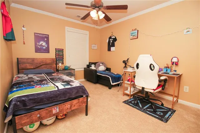 a bed sitting in a bedroom next to a window