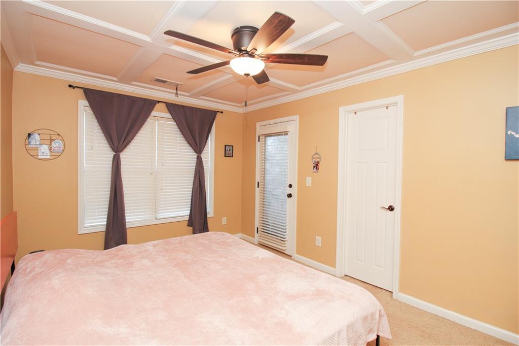 2508 Morgan Chase Drive Buford, GA 30519 - Photo 18 of 23 a bedroom with a large bed and a chandelier