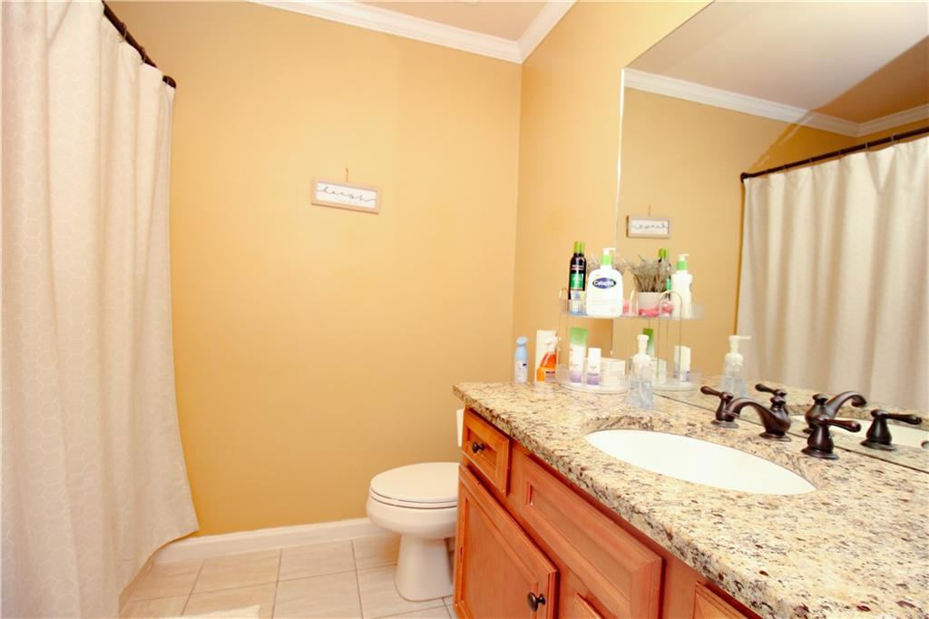 2508 Morgan Chase Drive Buford, GA 30519 - Photo 20 of 23 a bathroom with a granite countertop sink and a mirror