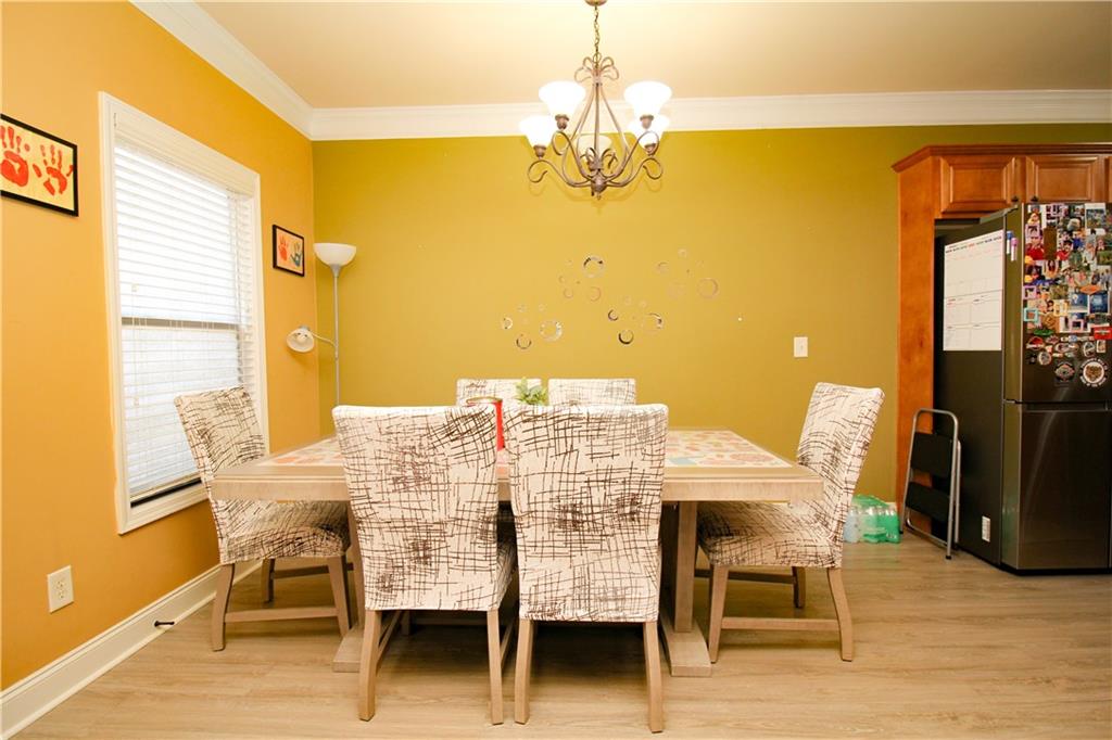 2508 Morgan Chase Drive Buford, GA 30519 - Photo 10 of 23 a view of a dining room with furniture and wooden floor