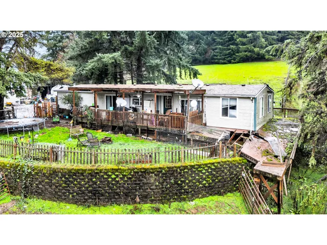 a view of a yard with furniture and wooden fence