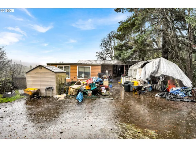 a view of a park with furniture and a wooden bench