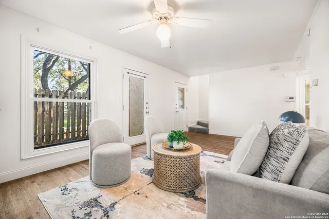 a living room with furniture and a potted plant