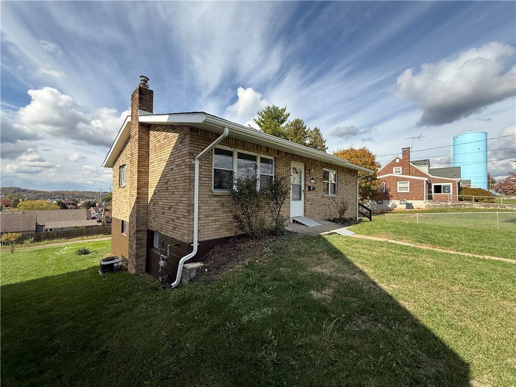 1433 Jones Street Monessen, PA 15062 - Photo 3 of 19 a view of a house with a big yard and a large tree