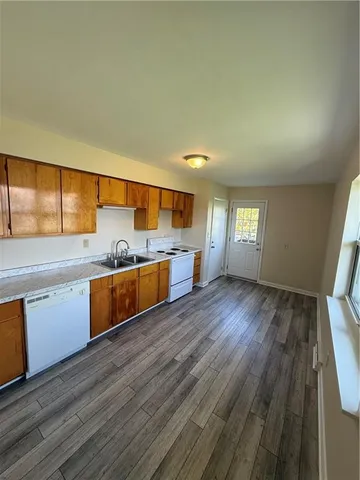 an empty room with windows and fan chandelier fan
