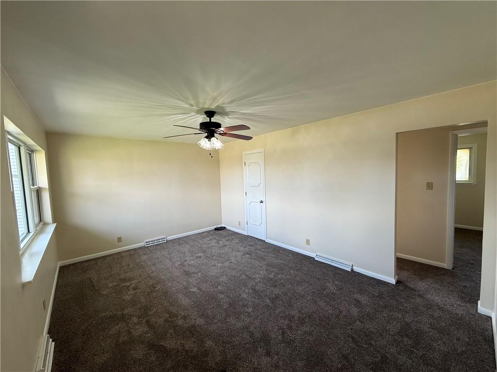 1433 Jones Street Monessen, PA 15062 - Photo 9 of 19 an empty room with windows and fan chandelier fan