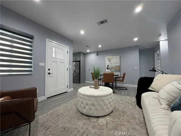 a living room with furniture and a potted plant