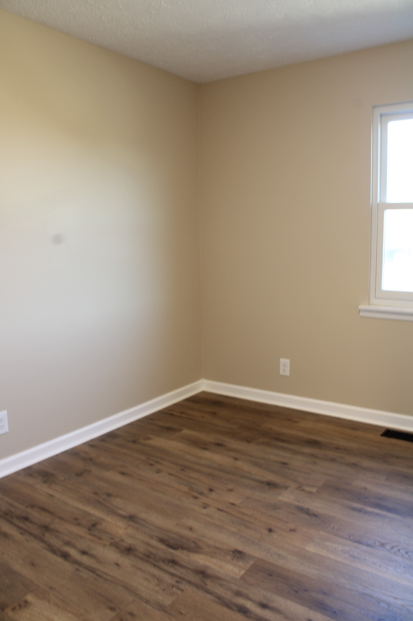 705 County House Road Sparta, TN 38583 - Photo 16 of 28 a view of an empty room with wooden floor and a window