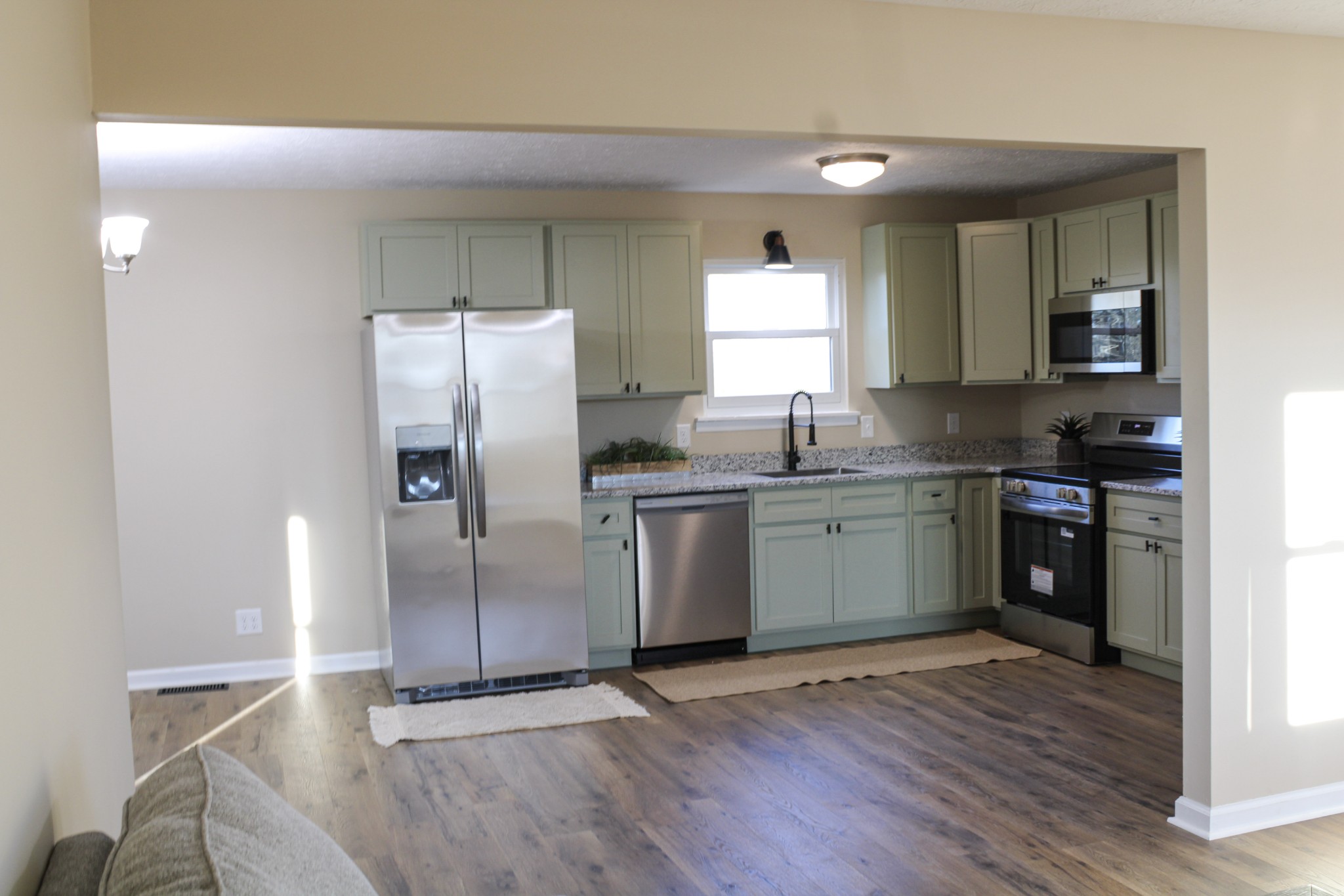 705 County House Road Sparta, TN 38583 - Photo 6 of 28 a kitchen with granite countertop a refrigerator and a sink