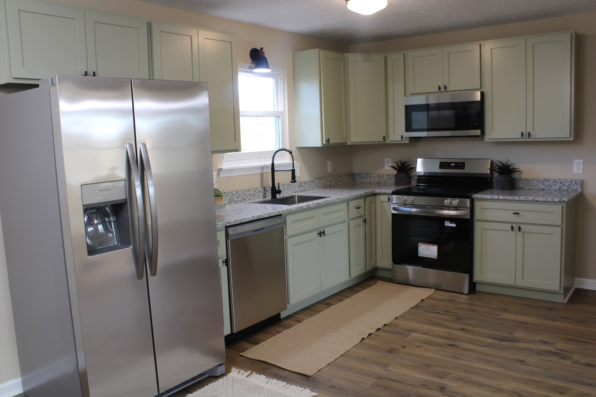 705 County House Road Sparta, TN 38583 - Photo 7 of 28 a kitchen with stainless steel appliances granite countertop a stove a sink and a refrigerator