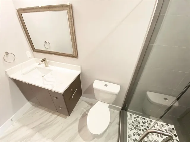 an empty room with a ceiling fan and a window