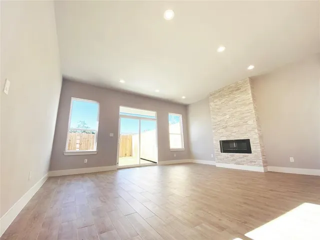 a large kitchen with granite countertop a large counter top a sink stainless steel appliances and cabinets