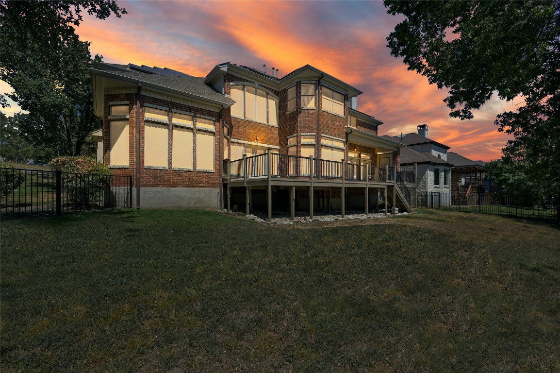 a view of a big house with a big yard and large trees