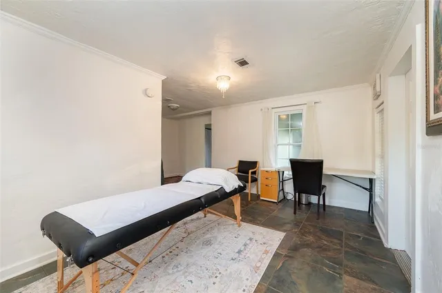 a bedroom with a bed and a desk