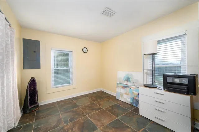 a room with a chair and a fireplace