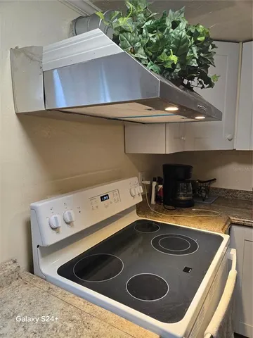a kitchen with a stove and a microwave