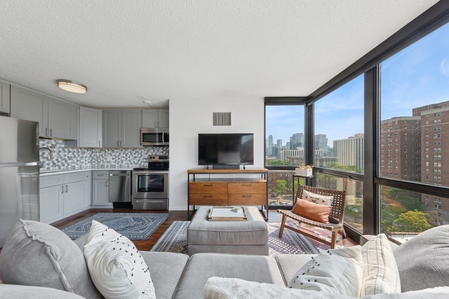 1122 North Clark Street, Unit 1002 Chicago, IL 60610 - Photo 5 of 14 a living room with furniture and a flat screen tv