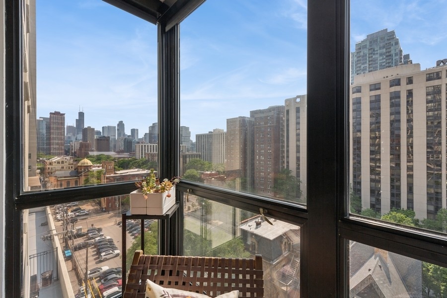 1122 North Clark Street, Unit 1002 Chicago, IL 60610 - Photo 6 of 14 a city view from a balcony