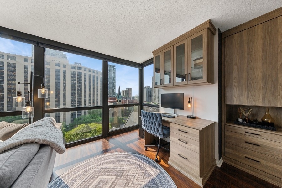 1122 North Clark Street, Unit 1002 Chicago, IL 60610 - Photo 7 of 14 a view of a workspace with furniture and a window