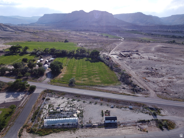 345 North Main Street Clawson, UT 84516 - Photo 3 of 17 Expansive property featuring a greenhouse structure, a small white building, and agricultural fields