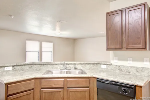 a kitchen with a sink cabinets and window
