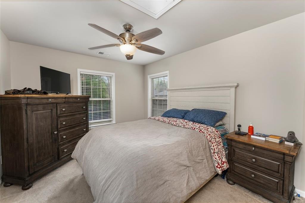 113 Tyson Woods Road Acworth, GA 30102 - Photo 32 of 37 a bedroom with a bed and a flat screen tv