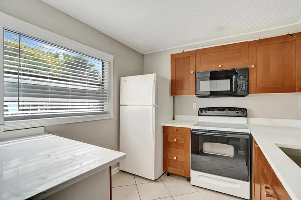 a kitchen with a stove microwave and refrigerator