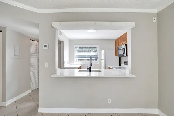 a view of kitchen cabinet and window