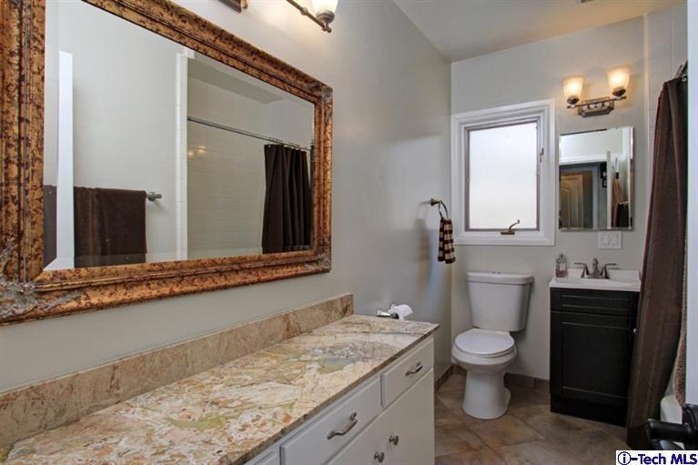 532 Alhambra Road San Gabriel, CA 91775 - Photo 18 of 28 a bathroom with a granite countertop toilet sink and mirror