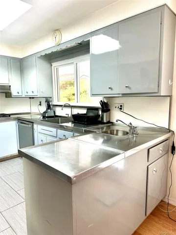 a kitchen with stainless steel appliances granite countertop a sink and a stove