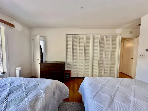 a bedroom with two beds and a window