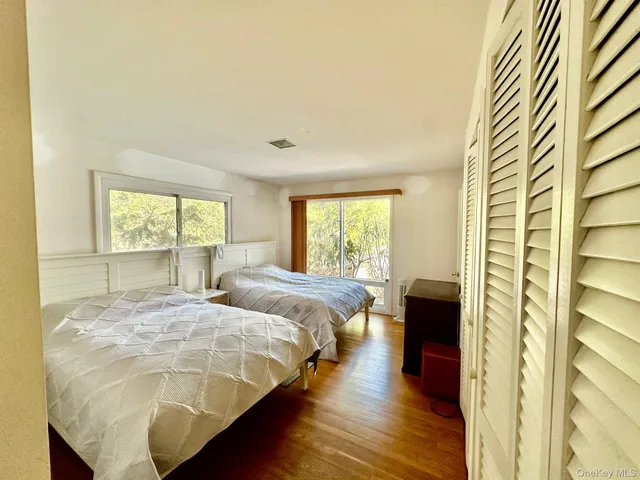a bedroom with two beds and a large window