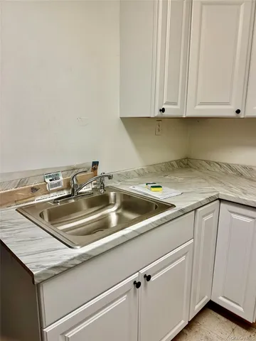 a kitchen with a sink and cabinets