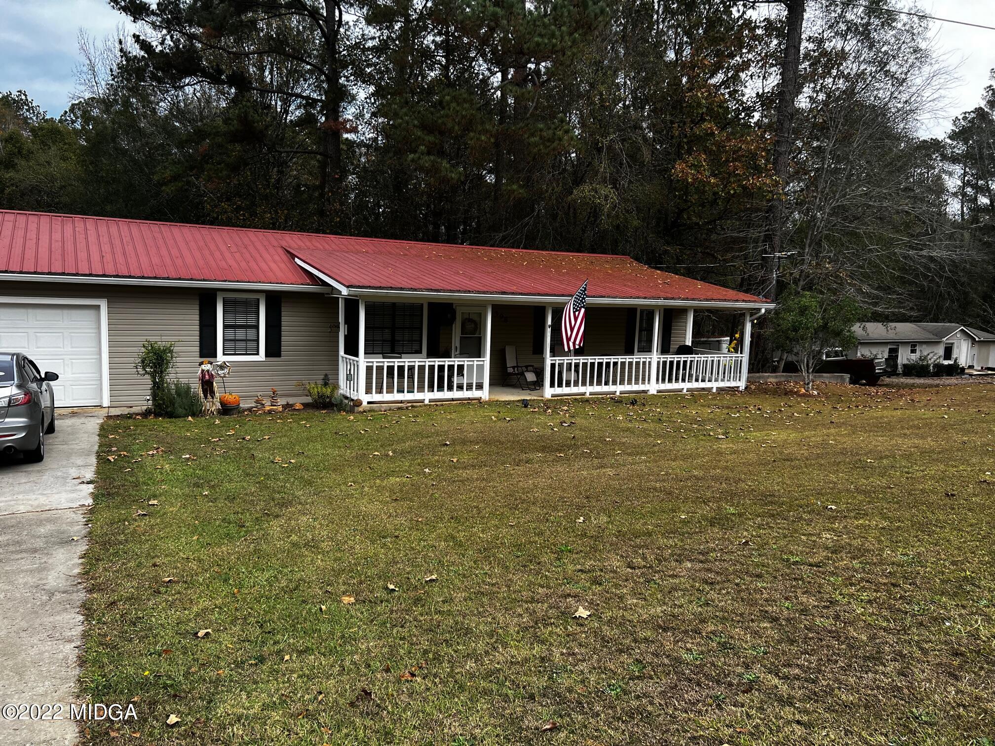 398 Old Benton Road Juliette, GA 31046 - Photo 1 of 31 a front view of a house with a garden