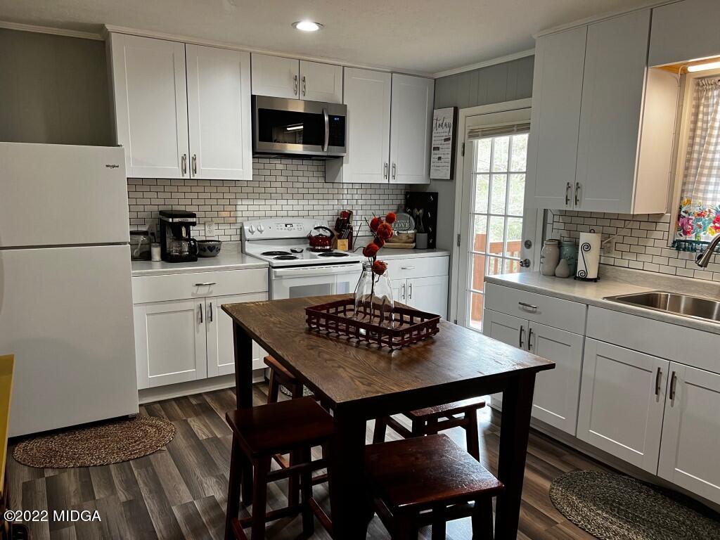398 Old Benton Road Juliette, GA 31046 - Photo 11 of 31 a kitchen with a dining table chairs and a refrigerator