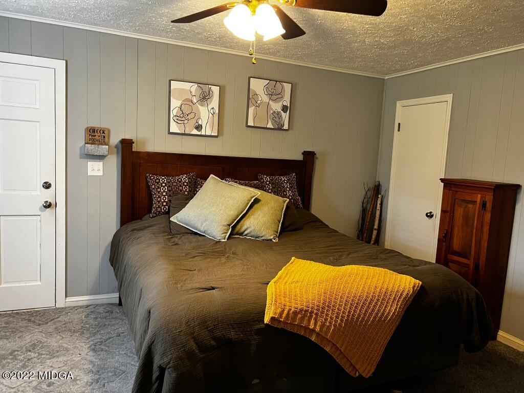398 Old Benton Road Juliette, GA 31046 - Photo 16 of 31 a bedroom with a bed and a chandelier