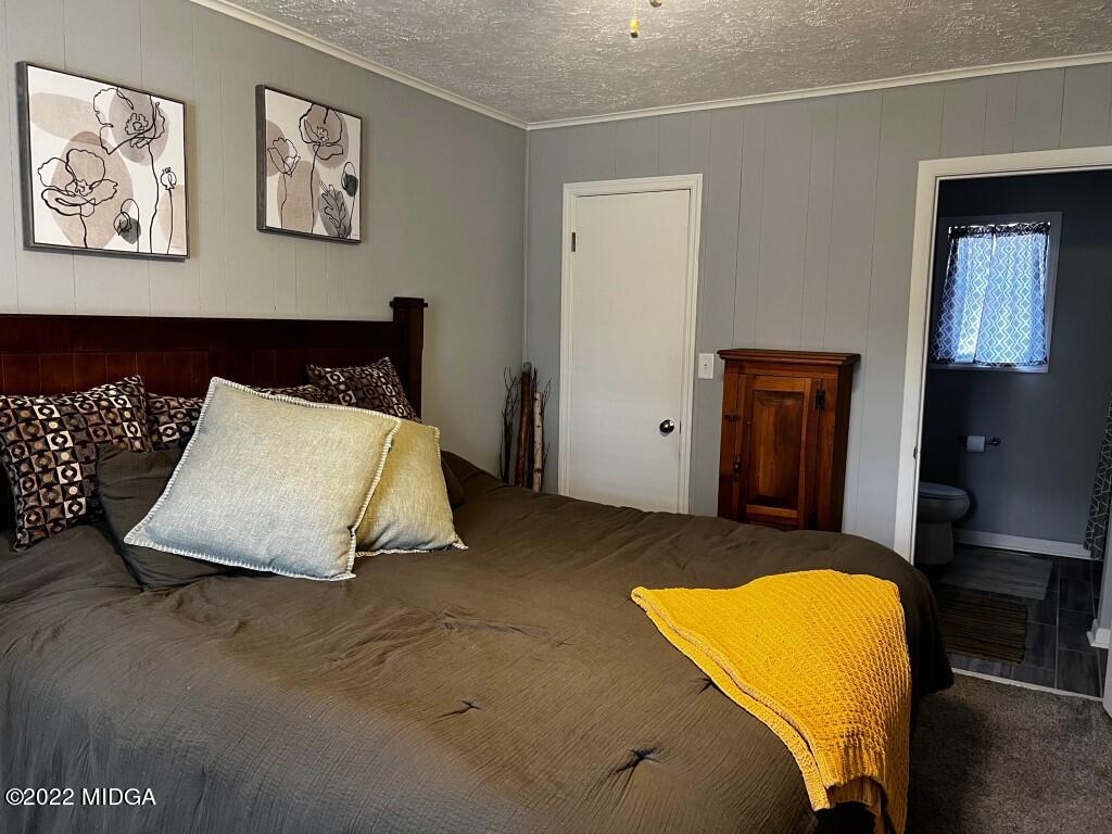 398 Old Benton Road Juliette, GA 31046 - Photo 17 of 31 a bedroom with a bed and wall painting