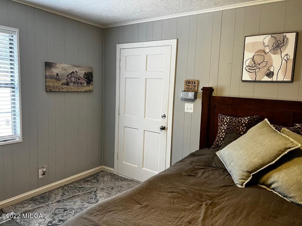 398 Old Benton Road Juliette, GA 31046 - Photo 18 of 31 a bedroom with a bed and painting on the wall