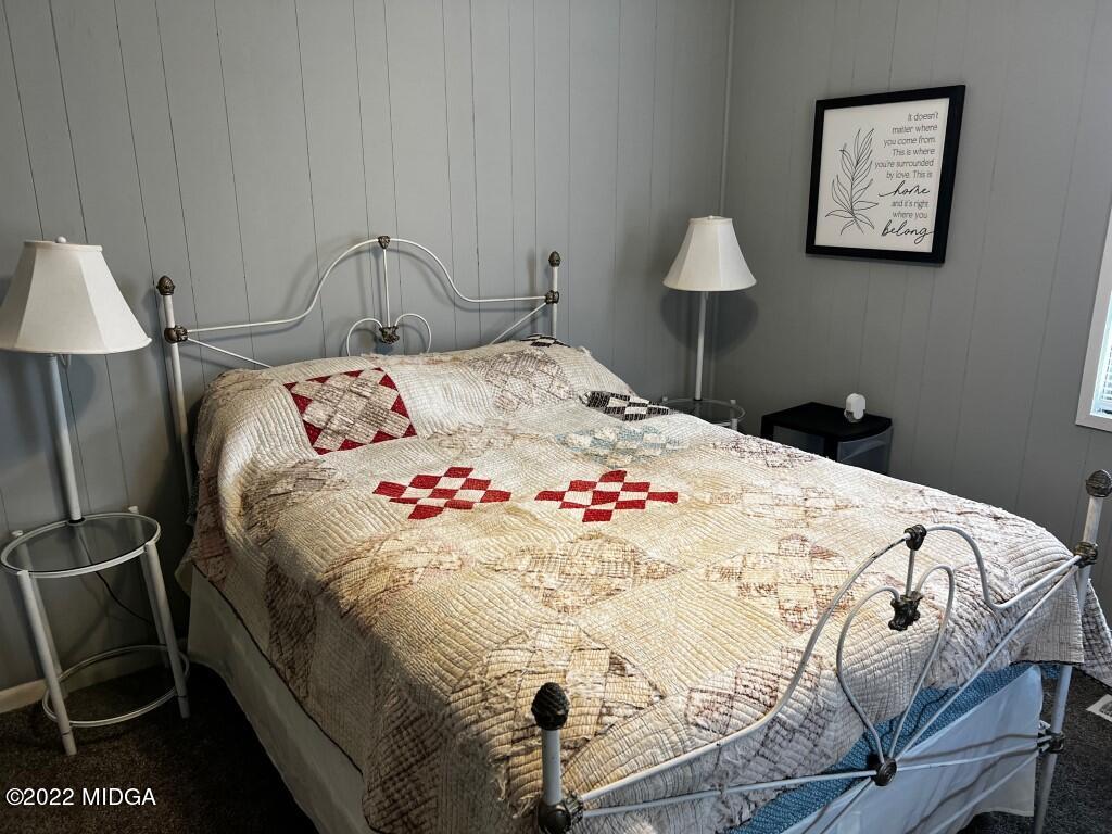 398 Old Benton Road Juliette, GA 31046 - Photo 21 of 31 a bedroom with a bed and a chair