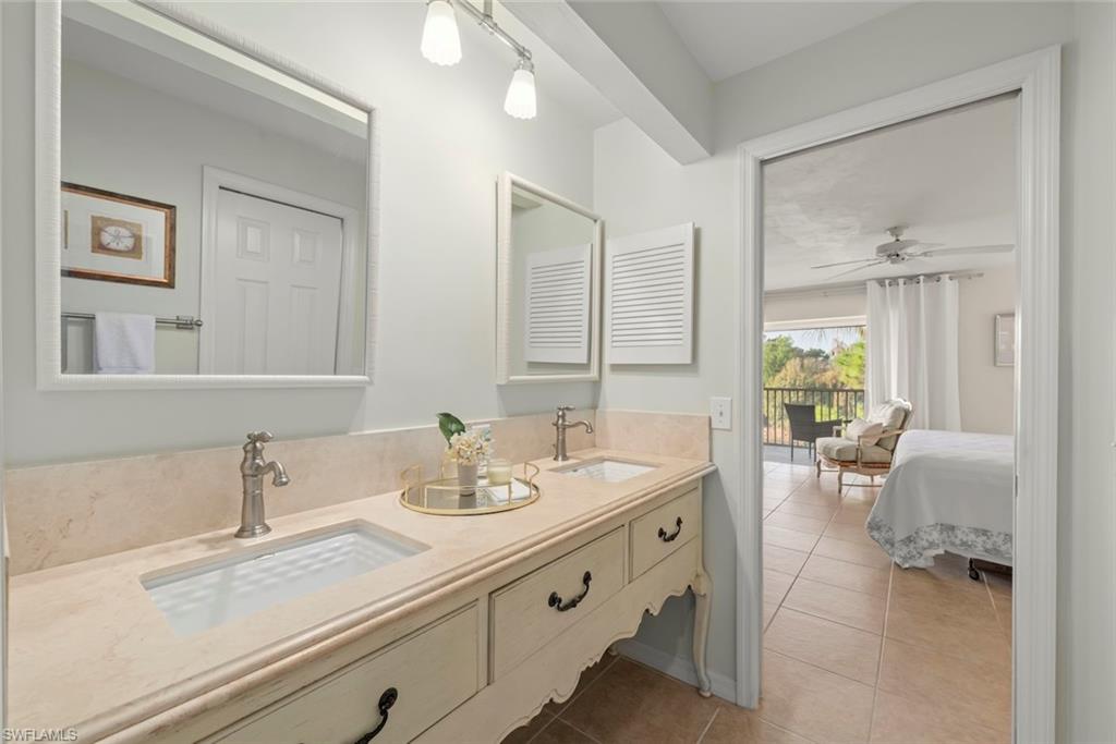 780 Waterford Drive, Unit 302 Naples, FL 34113 - Photo 13 of 47 a spacious bathroom with double sink and a mirror