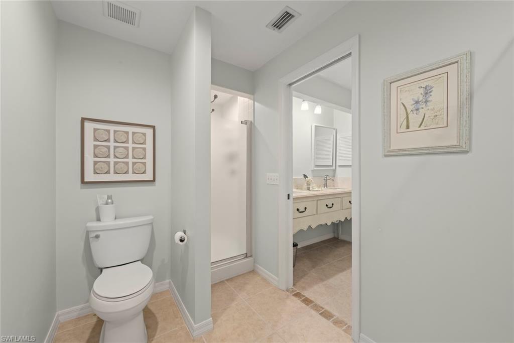 780 Waterford Drive, Unit 302 Naples, FL 34113 - Photo 15 of 47 a bathroom with a toilet sink and shower